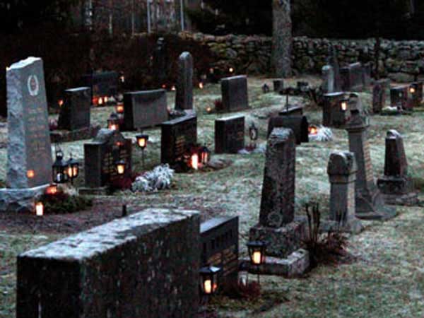 Cemetery at dusk with candles.