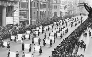 Women walking in big city parade
