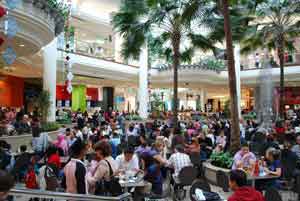 Shoppers taking break shopping in mall - Black Friday Shoppers taking break shopping in mall