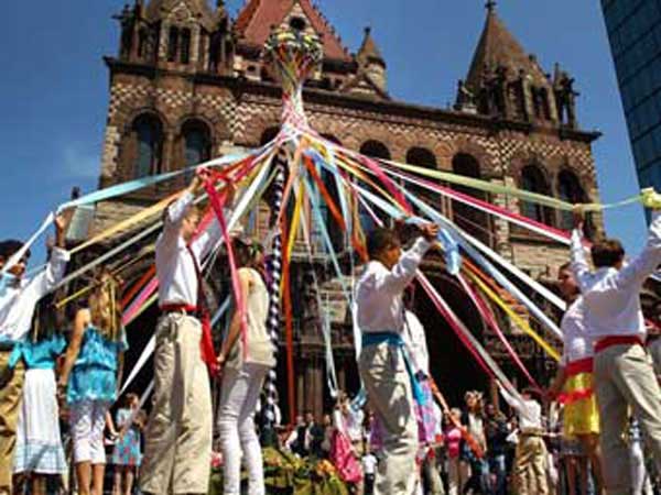 Children dancing around May pole.