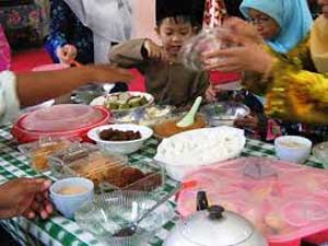 End of fasting and Muslim family enjoying a feast