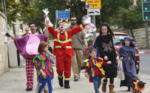 Family walking down street in Isreal celebrating Purim.