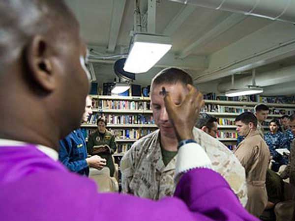 Ash Wednesday Navy chaplain distributes ashes to Marines on board USS Boxer.
