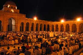 Muslim men praying outdoors