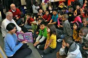 Teacher reading to young kids in class