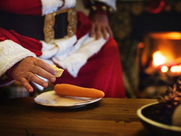 Santa having midnight snack that was left out for him on Christmas Eve.