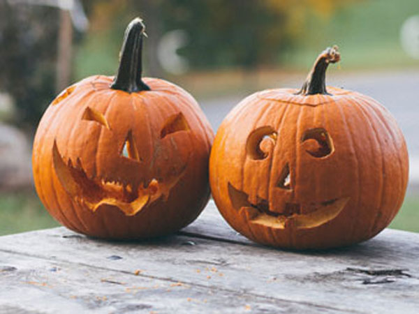 Two scary carved pumpkins on Halloween.