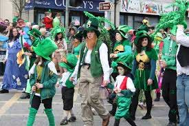 People walking in parade dressed in green with shamrocks - St Patricks Day People walking in parade dressed in green with shamrocks