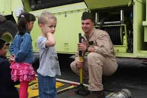 Fire fighter showing kids truck - Take our Daughters and Sons to Work Day Fire fighter showing kids truck