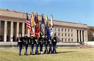 Military marching with armed forces flags