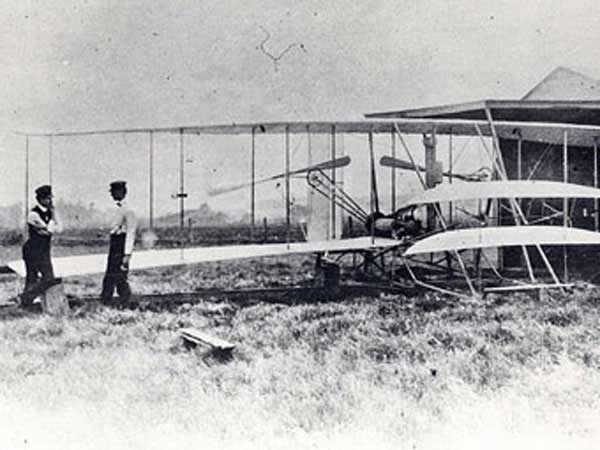 Wright Brothers Day Wright brothers Orville on left and Wilbur on the right in 1904 with the Wright Flyer 2 plane at Huffman Prairie.